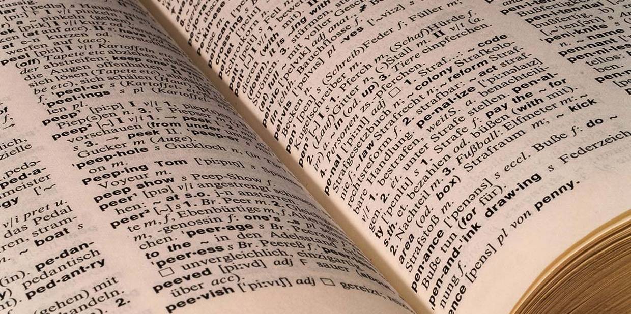 Foto mostra página de dicionário aberta